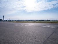 an empty airport runway has no cars on the tarmac at this time of day