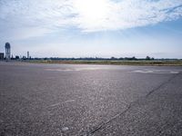 an empty airport runway has no cars on the tarmac at this time of day