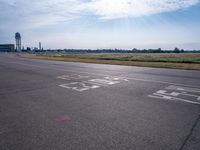 an empty airport runway has no cars on the tarmac at this time of day