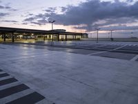 a building in an airport at night as the sun is set outside the windows,