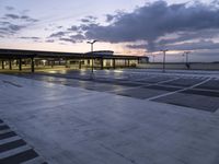 a building in an airport at night as the sun is set outside the windows,