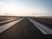 the sun is shining brightly across an airport runway with airplanes and people walking on the pavement