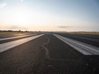 the sun is shining brightly across an airport runway with airplanes and people walking on the pavement