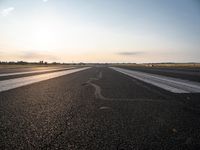 the sun is shining brightly across an airport runway with airplanes and people walking on the pavement