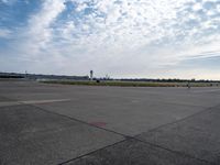 a couple of people are walking towards an airplane in the middle of a runway at an airport