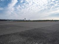 a couple of people are walking towards an airplane in the middle of a runway at an airport