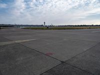 a couple of people are walking towards an airplane in the middle of a runway at an airport