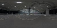 a panoramic view of an indoor airport terminal with curved roads and large buildings