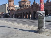 there is a large stone building in the background with columns and arches on either side