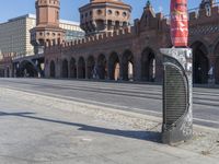 there is a large stone building in the background with columns and arches on either side