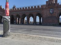 there is a large stone building in the background with columns and arches on either side