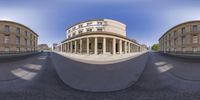 a fish eye view of a building and sidewalk with pillars and columns, seen from the bottom up