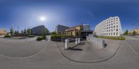 the view of buildings and a street through a fish eye lens lens in a city