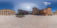 a very large brick building in a large circle next to other brick buildings and people