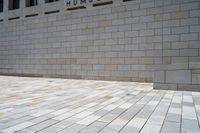 a small brick patio and a wall with an open door in the background, on which the floor is mostly empty