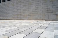 a small brick patio and a wall with an open door in the background, on which the floor is mostly empty