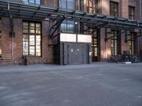 the view down the street toward an empty parking lot with bicycles parked and the entrance to the building