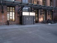 the view down the street toward an empty parking lot with bicycles parked and the entrance to the building