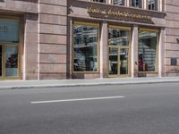 a building with three windows and two bikes parked on the street outside of it and a sign reading wickersho