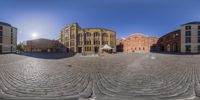 a fish - eye lens photo of buildings and a fountain in front of one another