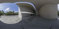 a large gray object is seen in this 360 - eye view photograph with a building's circular doorway