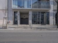 there is a fire hydrant in front of the building on the street corner and a black fire hydrant in the distance