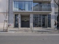 there is a fire hydrant in front of the building on the street corner and a black fire hydrant in the distance