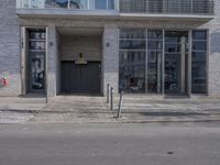 there is a fire hydrant in front of the building on the street corner and a black fire hydrant in the distance