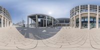 the reflection of a building's courtyard in a spherical 360 - pane lens