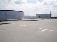a boat is parked in an empty parking lot near an air port on the water