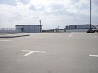 a boat is parked in an empty parking lot near an air port on the water