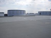 a boat is parked in an empty parking lot near an air port on the water