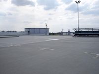 a boat is parked in an empty parking lot near an air port on the water