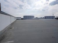 a boat is parked in an empty parking lot near an air port on the water