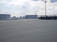 a boat is parked in an empty parking lot near an air port on the water
