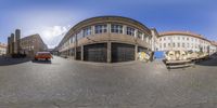 a fish eye lens with an old building in the background and street signs on it