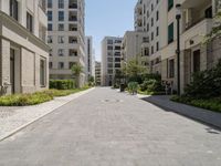 one long and narrow driveway in the middle of an empty city street with many buildings in the background