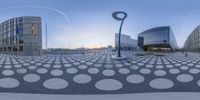 some nice circles in front of a big building that has been constructed up into the shape of a tree