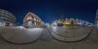 a fish eye view of some buildings at night time taken with the fish eye lens