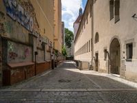 an empty cobblestone street with no people in the middle of it and buildings all around