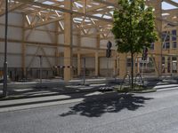 the street is quiet during the day with an under construction structure near it as seen from a road