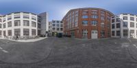 this is a view of a very small street with no cars on it, and the buildings are in perspective as if from the point of fisheye