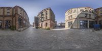 the 360 view shows an old building with red brick on the side and yellow, bricked building behind