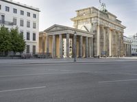 a photo of a building that looks like an architectural structure with columns and pillars, in front of buildings