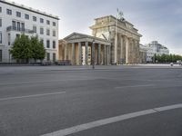 a photo of a building that looks like an architectural structure with columns and pillars, in front of buildings