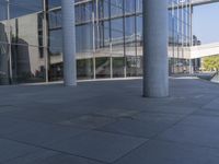 an empty building with a man sitting by it on the ground with his feet up in a fountain