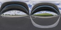 three fisheye pictures of a curve on the road in front of a building with columns