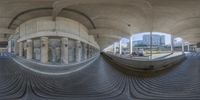 a spherical view of the inside of a building shows curved flooring and decorative columns