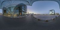 360 - view photograph of a building and courtyard during the day and evening in an oval frame