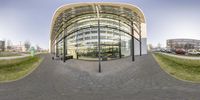 the photo was taken looking up at the building's curved exterior and glass walls